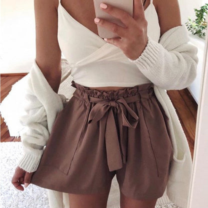Woman wearing mocha brown paperbag waist shorts with tie.