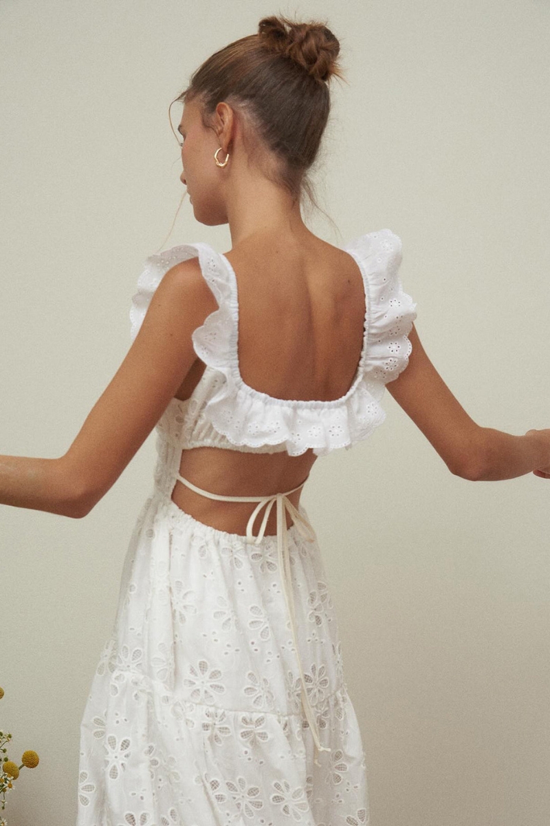 Woman in white eyelet maxi dress with ruffle sleeves