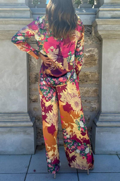 Woman in floral satin pantsuit standing on patio