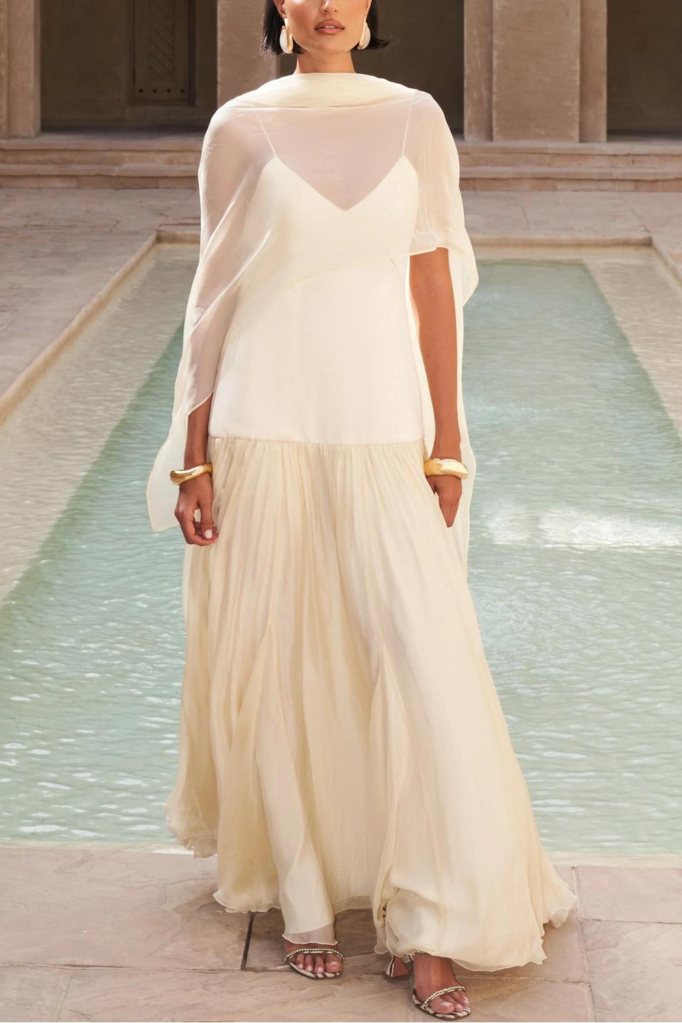 Woman in ivory chiffon maxi dress
