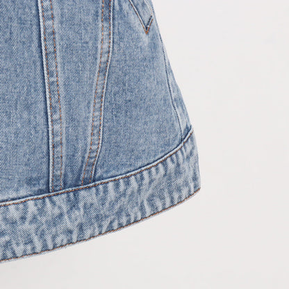 Woman wearing light wash denim skort with button detail