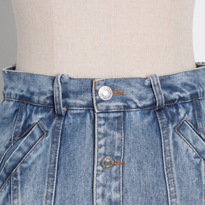 Woman wearing light wash denim skort with button detail