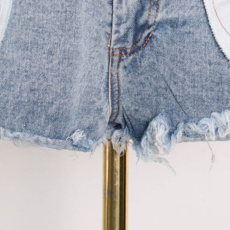 Woman wearing light wash denim skort with button detail