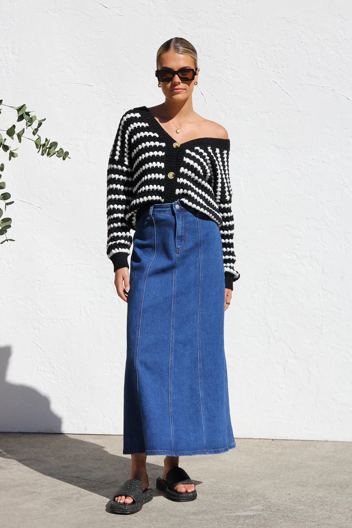 Woman wearing a blue denim maxi skirt with panelled design