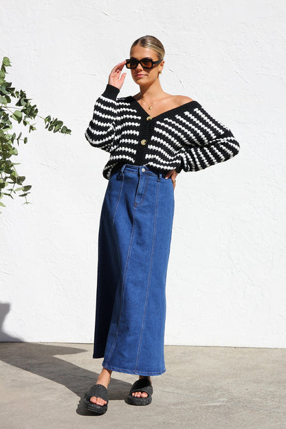 Woman wearing a blue denim maxi skirt with panelled design