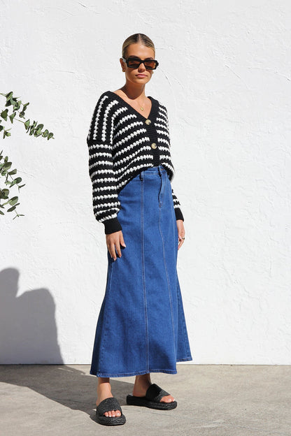 Woman wearing a blue denim maxi skirt with panelled design