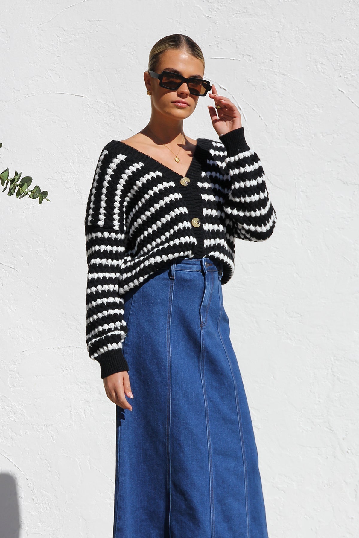 Woman wearing a blue denim maxi skirt with panelled design