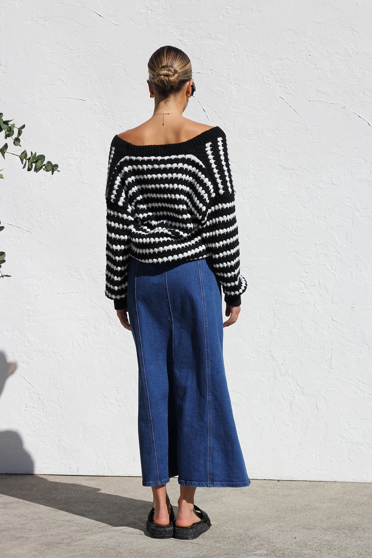 Woman wearing a blue denim maxi skirt with panelled design