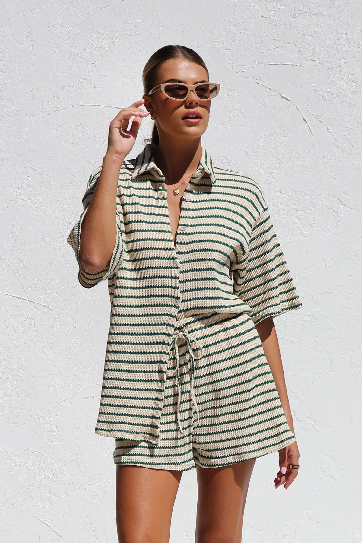 Woman in striped ribbed knit shirt and shorts set