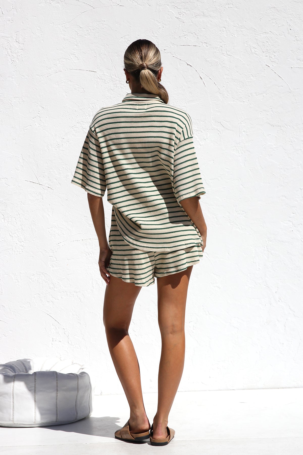 Woman in striped ribbed knit shirt and shorts set