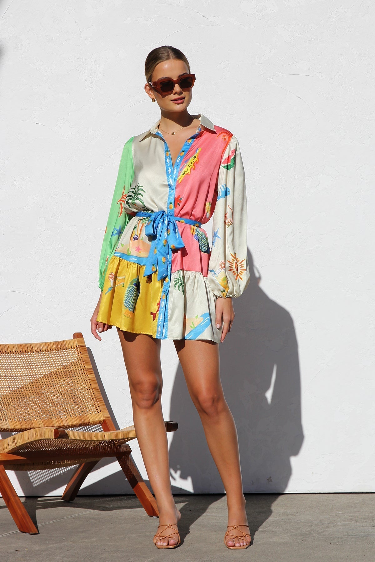 Woman in multicolor silk shirt dress with tropical print