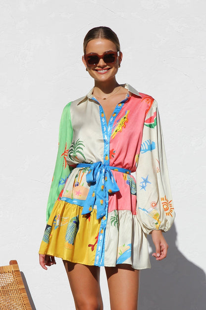 Woman in multicolor silk shirt dress with tropical print