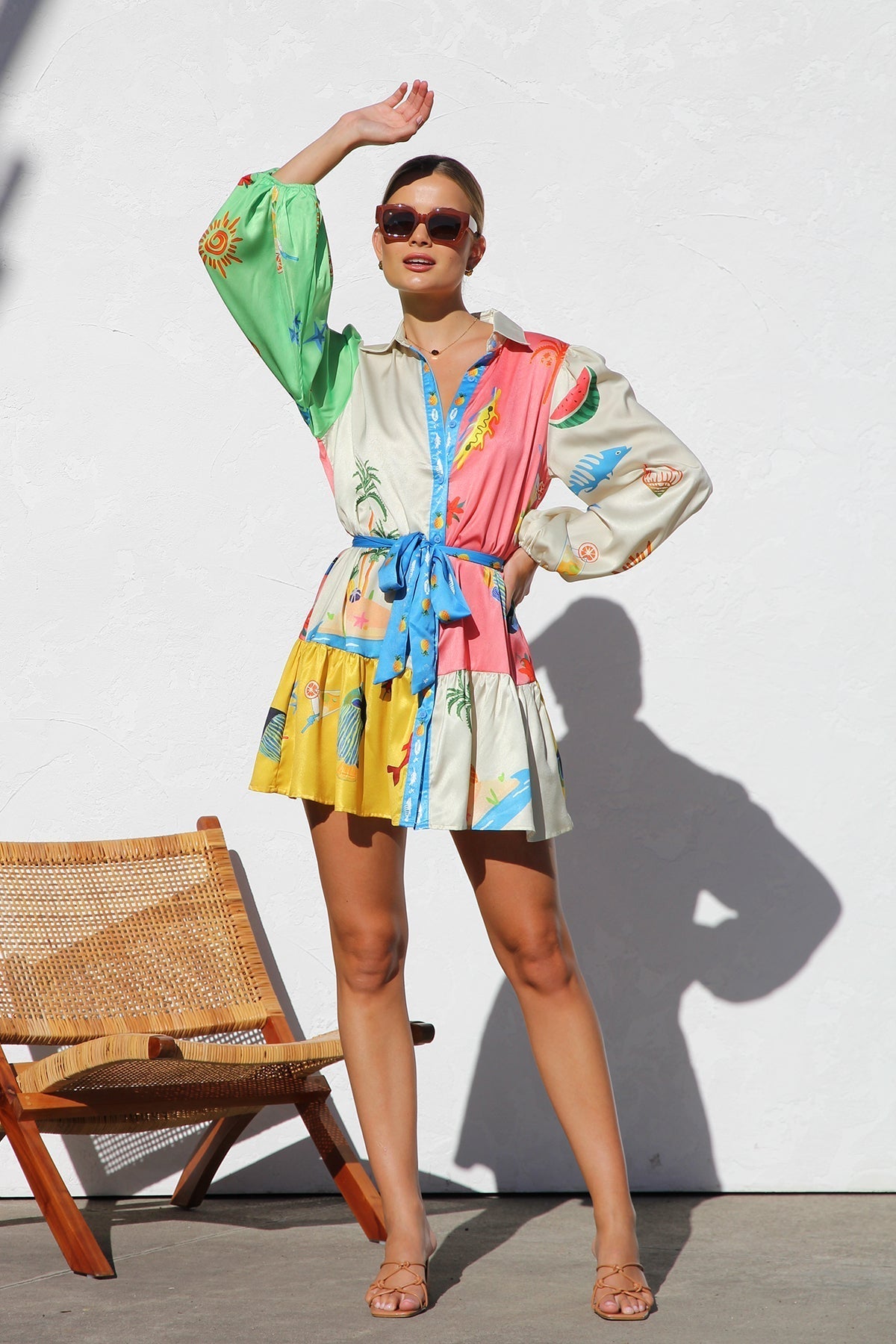 Woman in multicolor silk shirt dress with tropical print