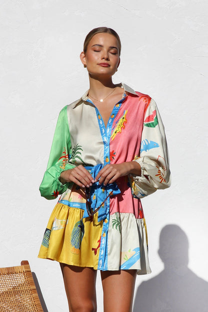 Woman in multicolor silk shirt dress with tropical print