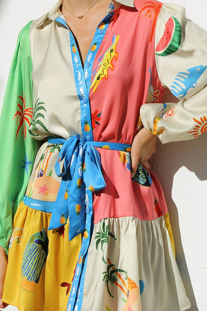 Woman in multicolor silk shirt dress with tropical print