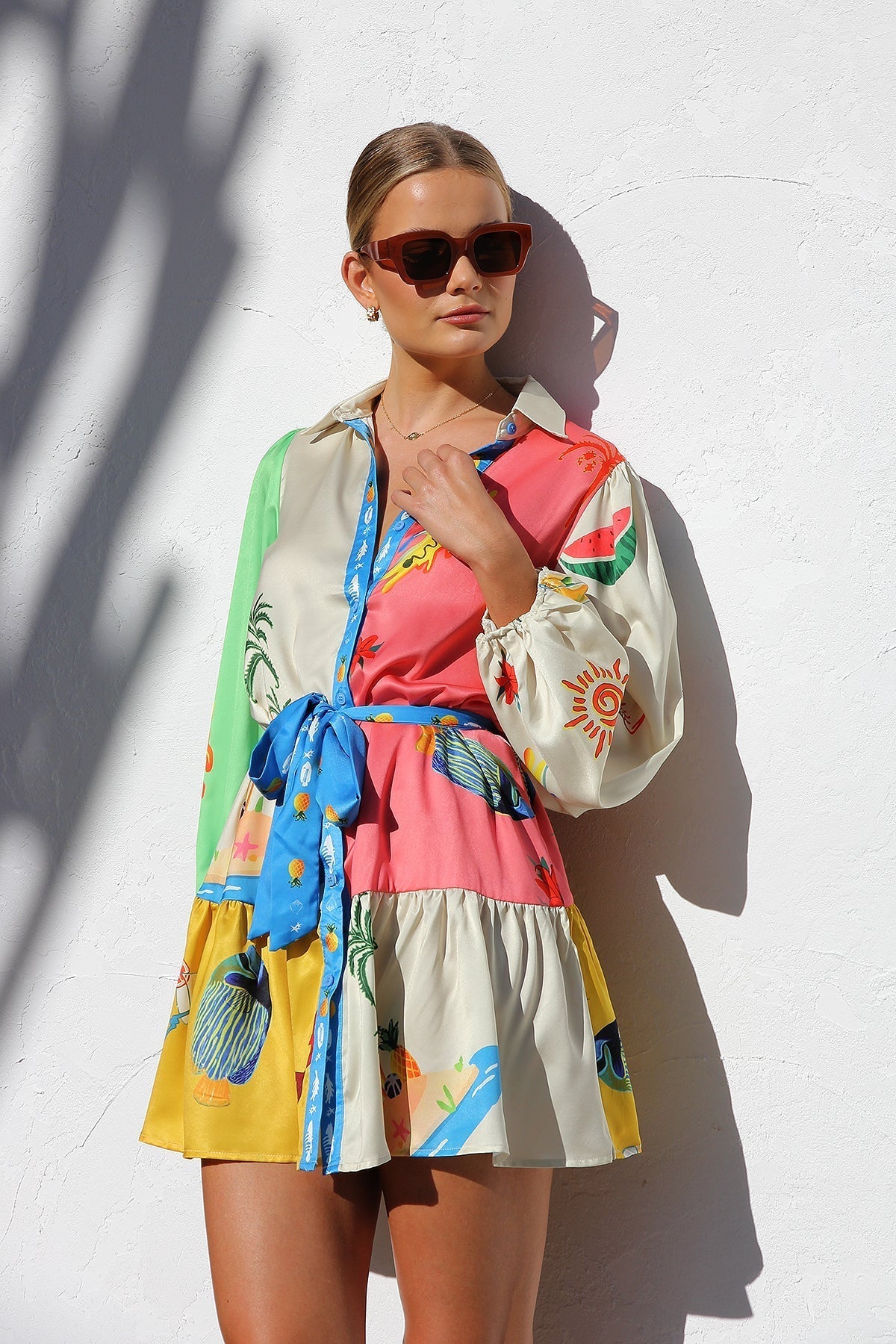 Woman in multicolor silk shirt dress with tropical print