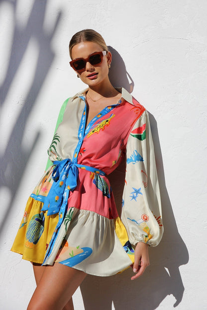 Woman in multicolor silk shirt dress with tropical print