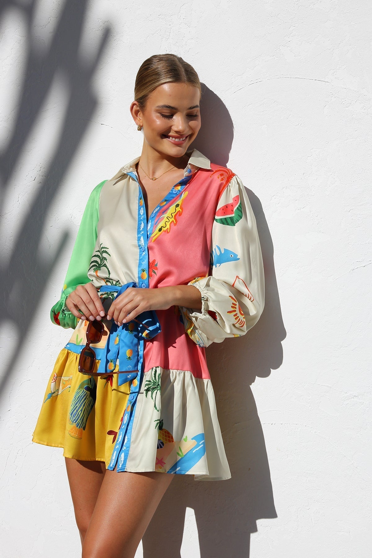 Woman in multicolor silk shirt dress with tropical print