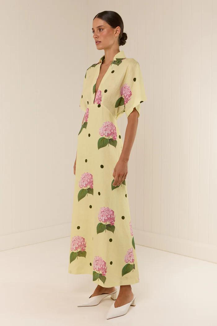 Woman in yellow linen maxi dress with pink hydrangea print