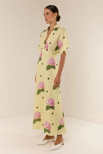 Woman in yellow linen maxi dress with pink hydrangea print