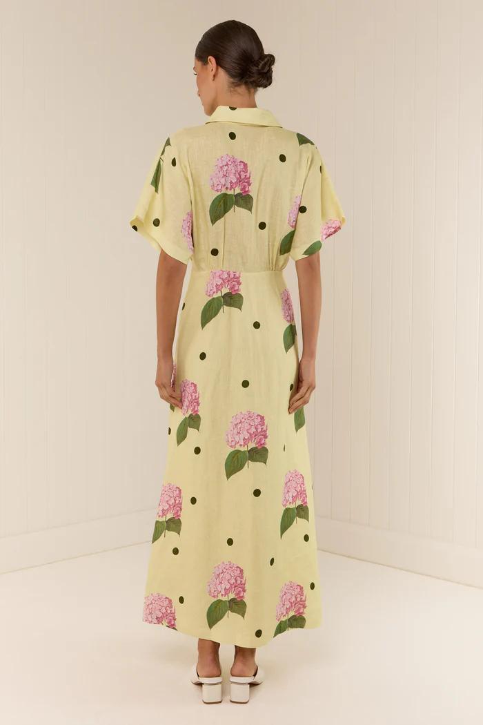 Woman in yellow linen maxi dress with pink hydrangea print