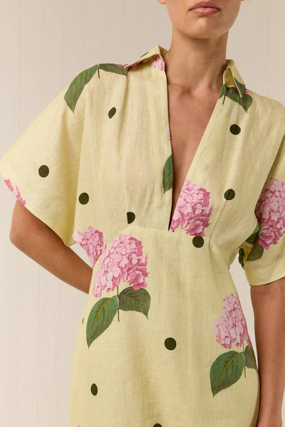 Woman in yellow linen maxi dress with pink hydrangea print