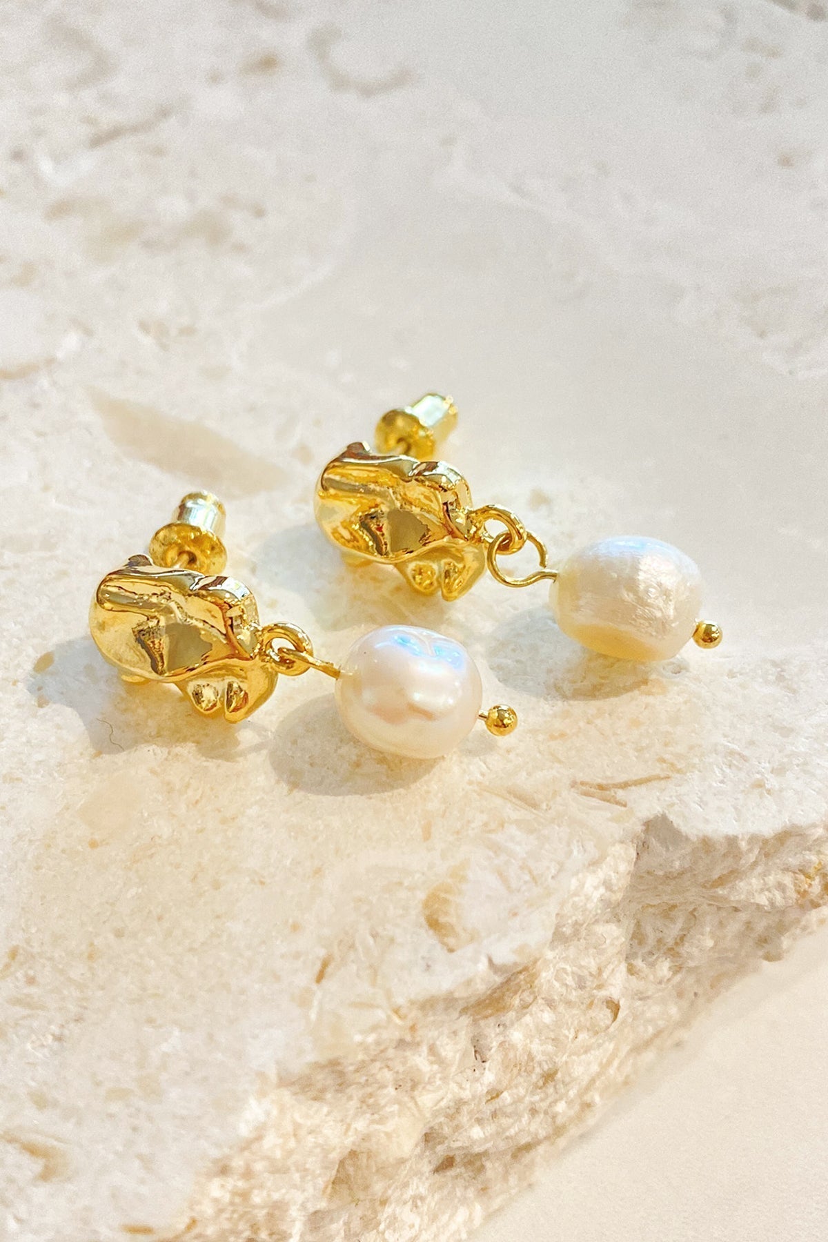 Close up of gold vermeil drop earrings with pearl