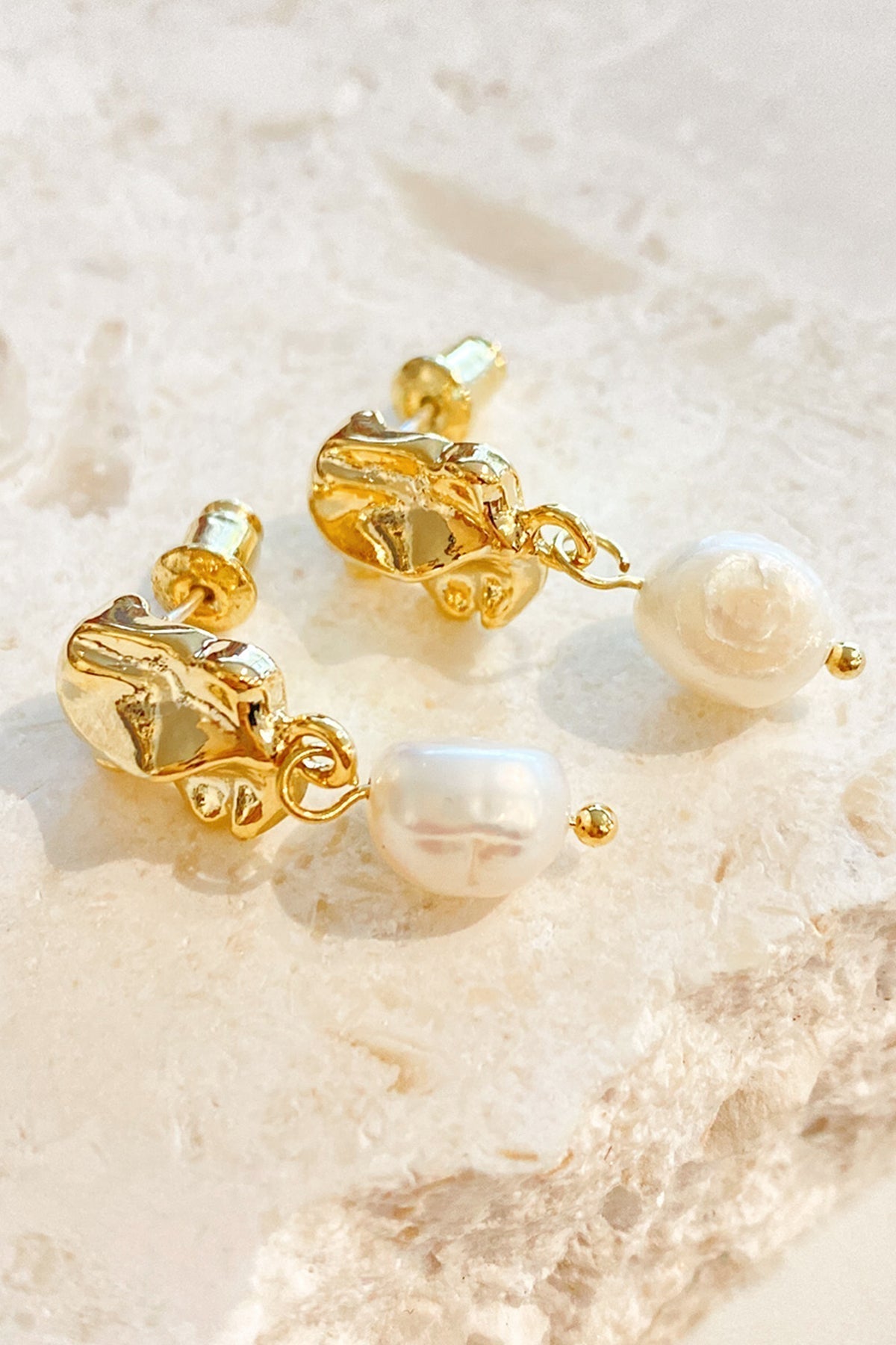Close up of gold vermeil drop earrings with pearl