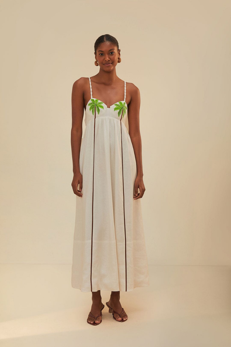 Woman in off-white linen sundress with palm tree appliques