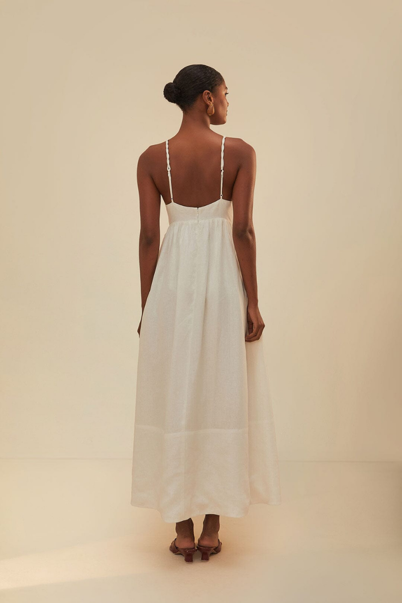 Woman in off-white linen sundress with palm tree appliques