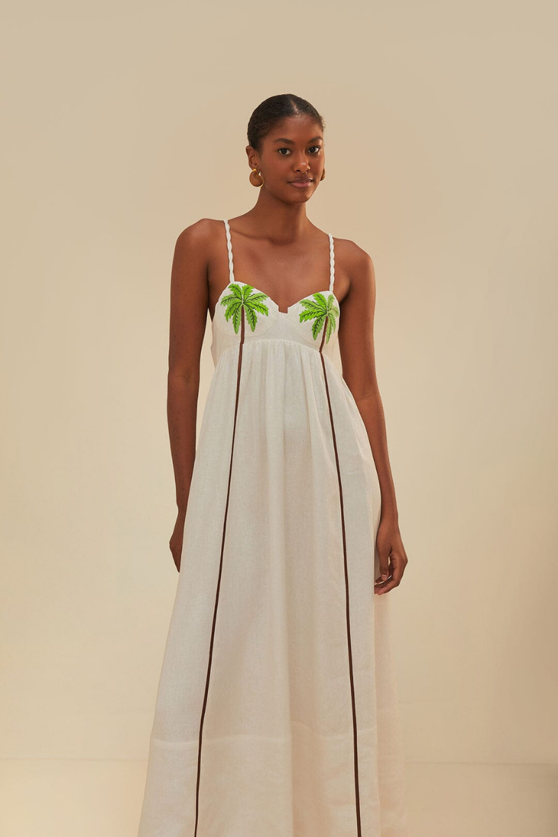 Woman in off-white linen sundress with palm tree appliques