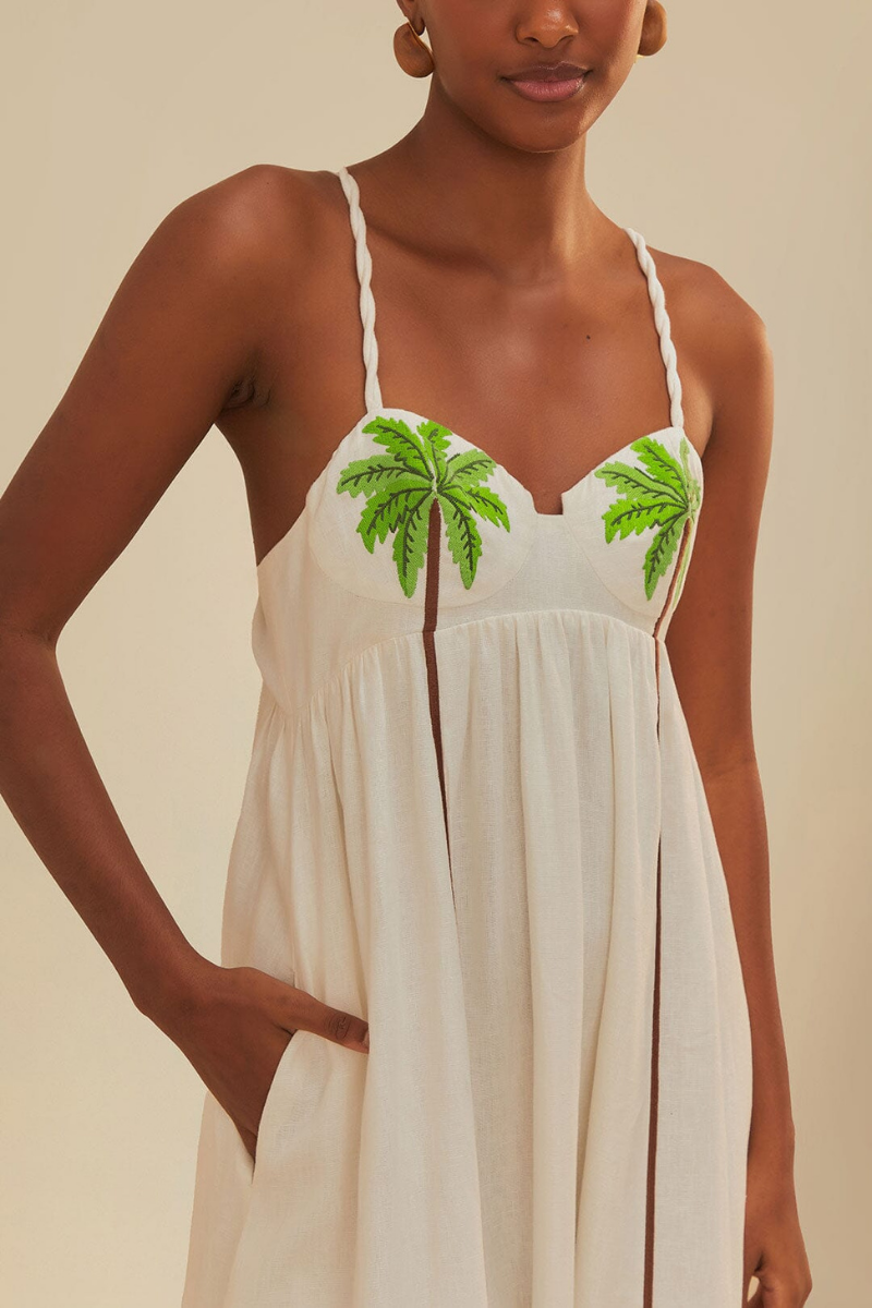 Woman in off-white linen sundress with palm tree appliques