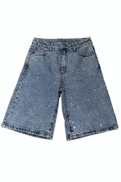 Woman wearing light wash denim bermuda shorts with sparkly embellishments