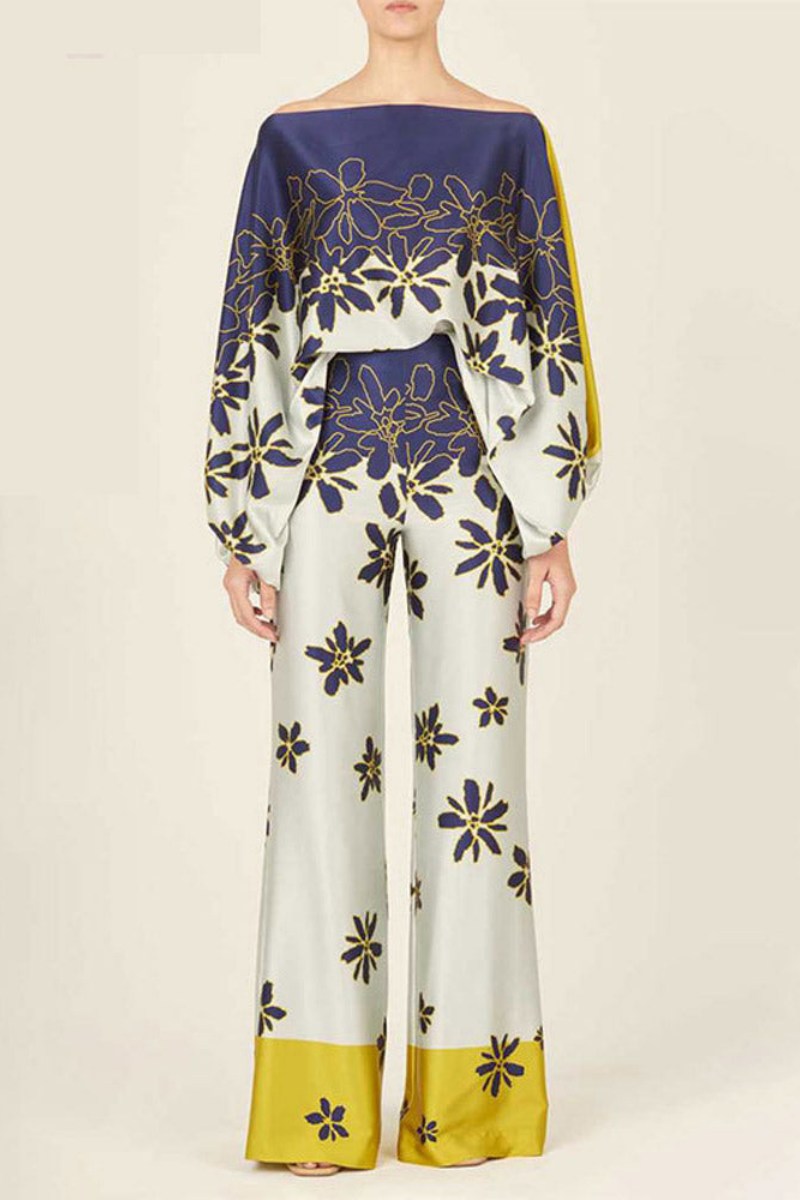 Woman wearing a blue and yellow silk floral print two-piece set.