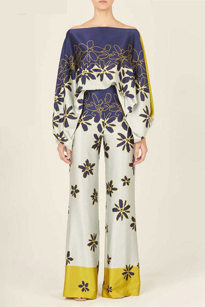 Woman wearing a blue and yellow silk floral print two-piece set.