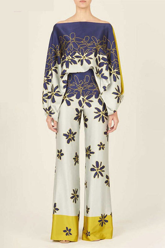 Woman wearing a blue and yellow silk floral print two-piece set.