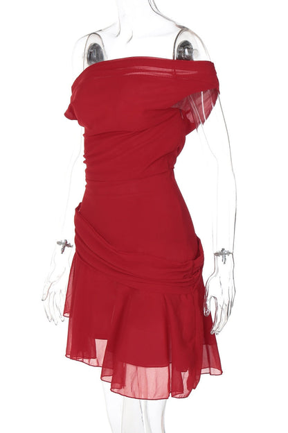 Woman in red chiffon mini dress crouching