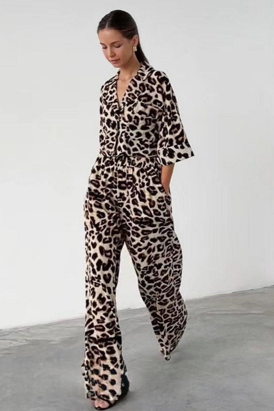 Woman wearing leopard print satin pajama set