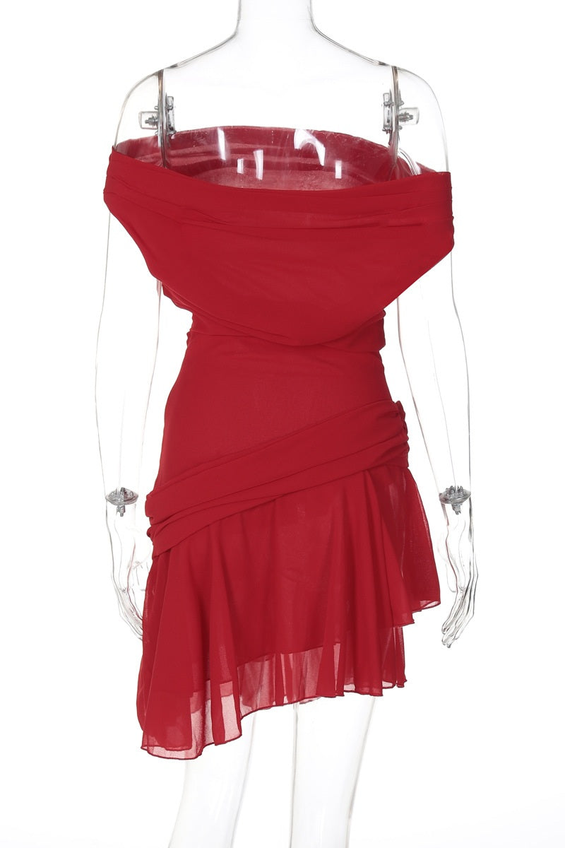 Woman in red chiffon mini dress crouching