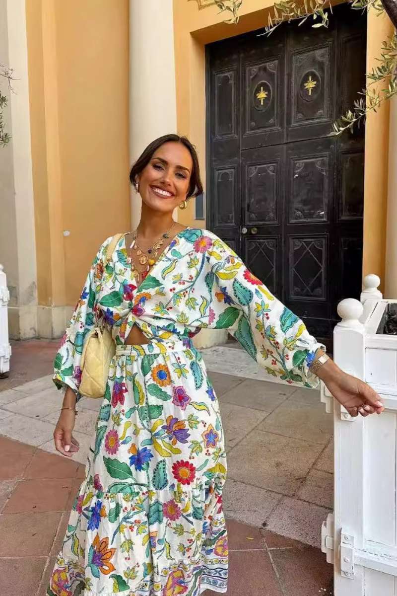 Woman wearing a floral print cotton maxi dress with a cutout waist.