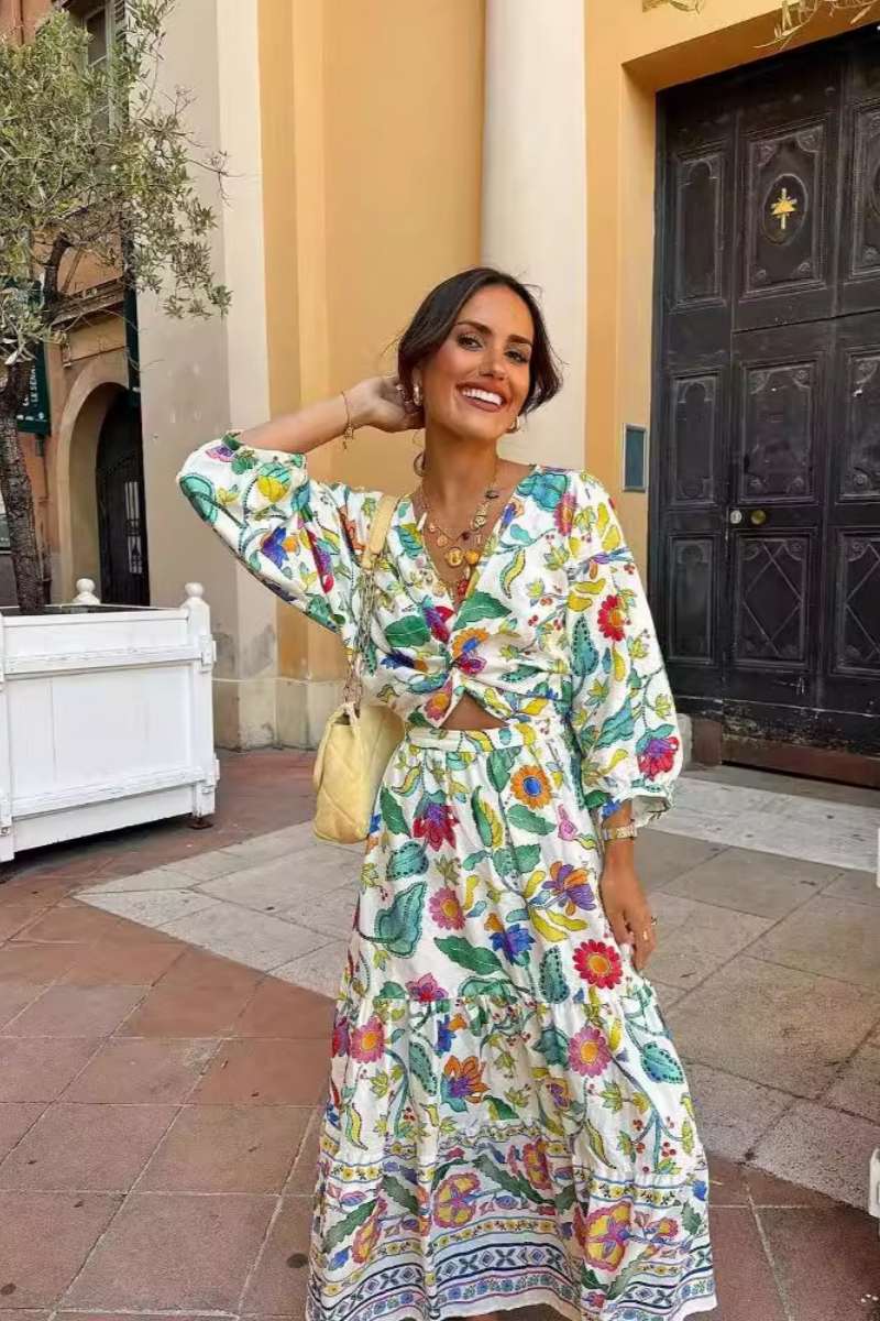 Woman wearing a floral print cotton maxi dress with a cutout waist.