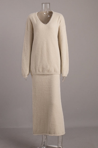 Woman in off-white boucle knit sweater and maxi skirt set with fuzzy slippers