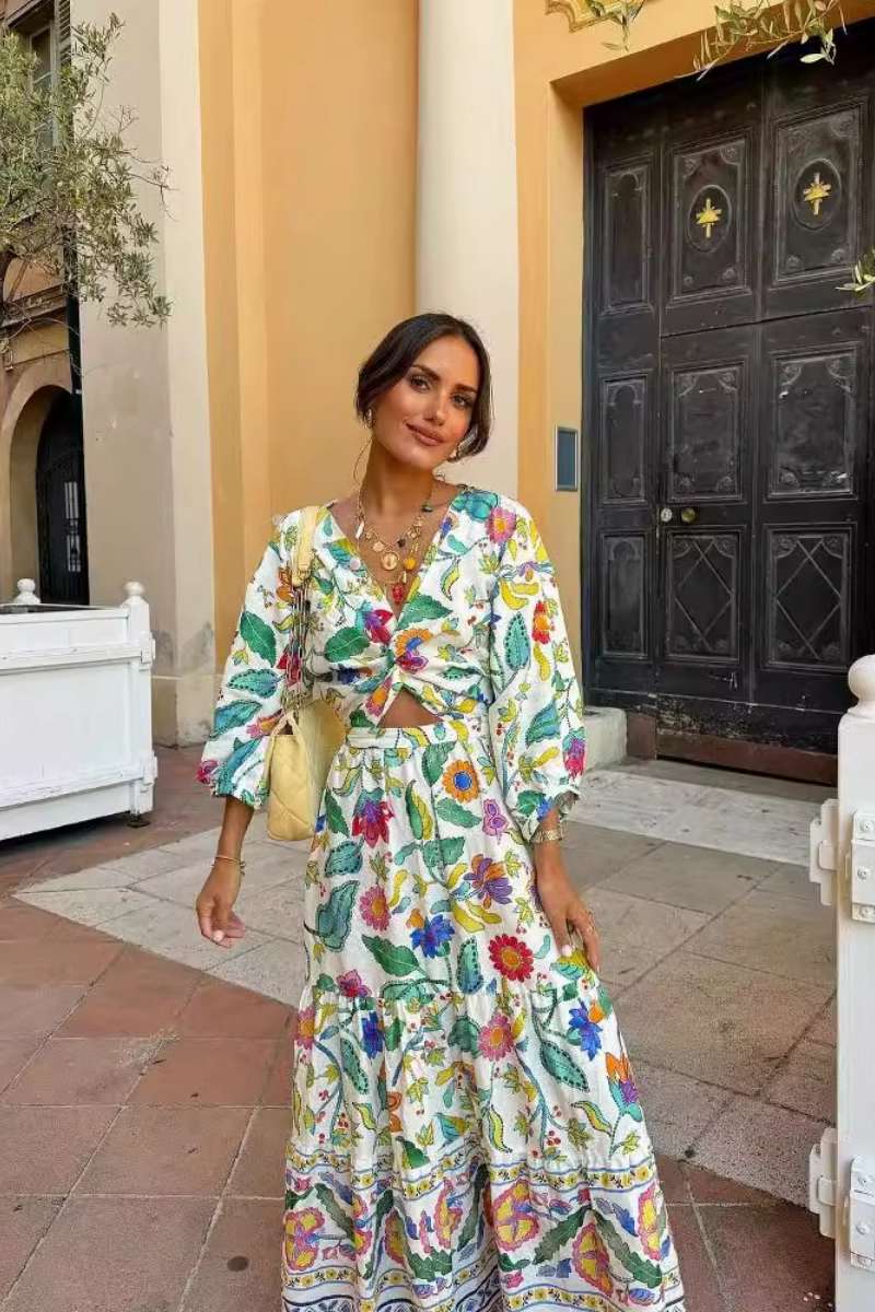 Woman wearing a floral print cotton maxi dress with a cutout waist.