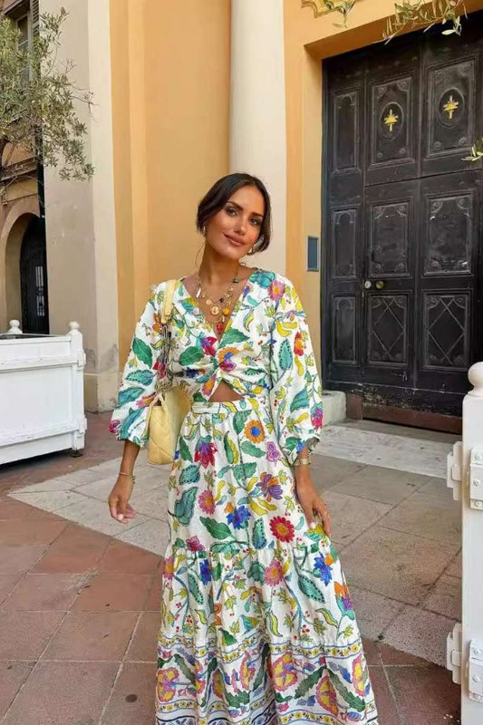 Woman wearing a floral print cotton maxi dress with a cutout waist.