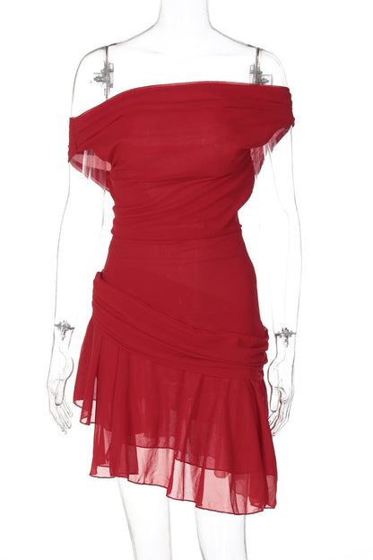 Woman in red chiffon mini dress crouching