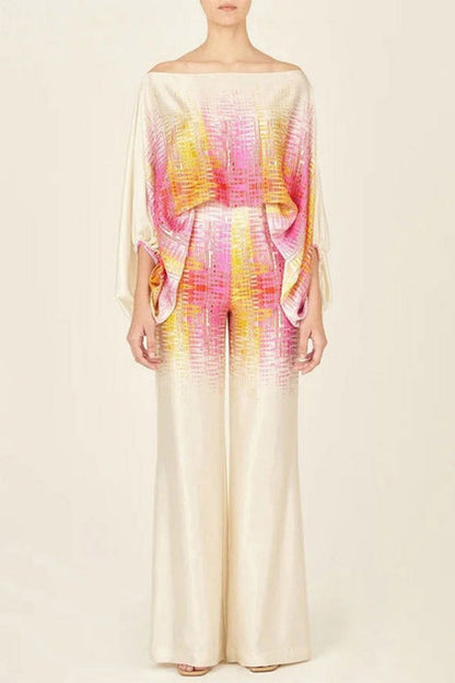 Woman wearing ivory, pink, and yellow satin two-piece set.