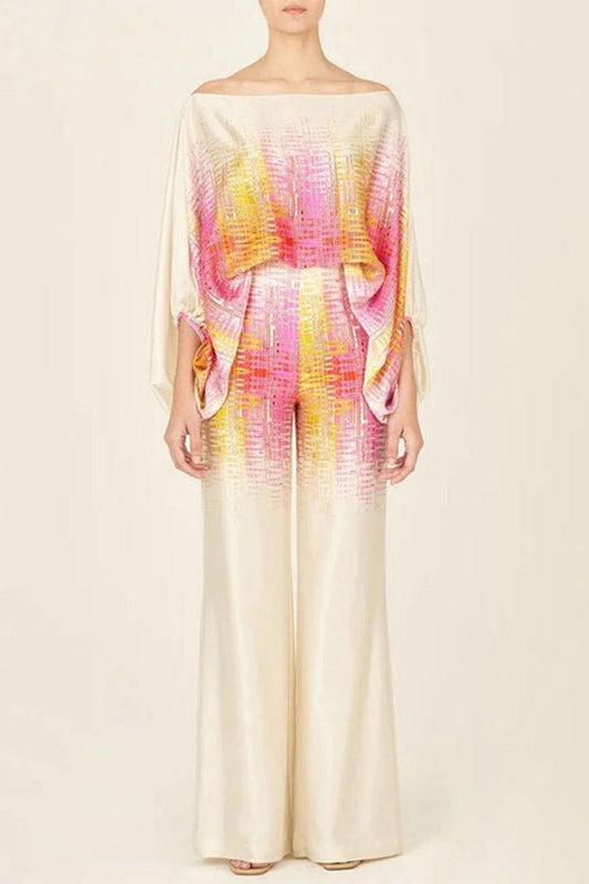 Woman wearing ivory, pink, and yellow satin two-piece set.