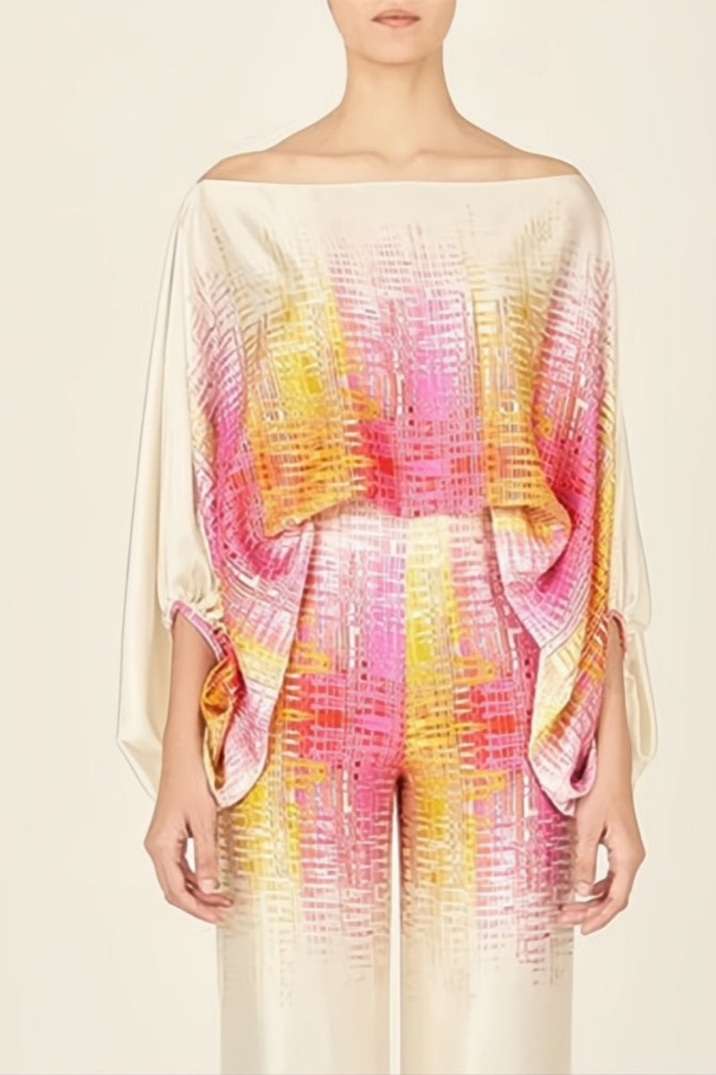 Woman wearing ivory, pink, and yellow satin two-piece set.