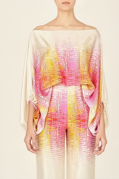 Woman wearing ivory, pink, and yellow satin two-piece set.