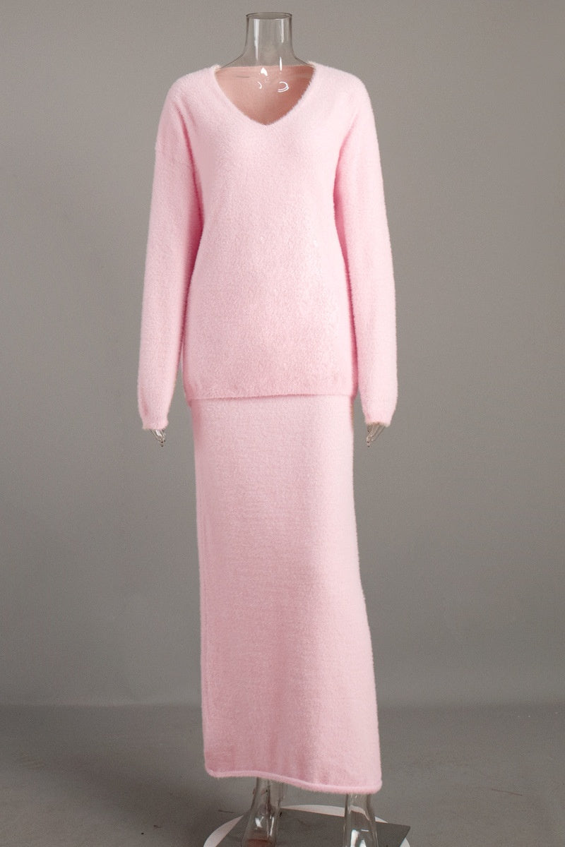 Woman in off-white boucle knit sweater and maxi skirt set with fuzzy slippers
